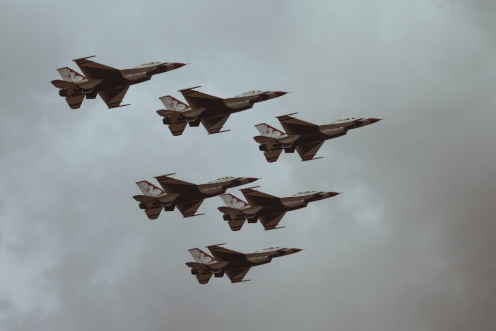 Taiwanese fighter jets scramble on a runway as military personnel prepare for rapid response to Chinese aircraft crossing the median line.