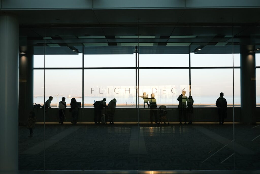 Chinese tourists boarding a repatriation flight at a Philippine airport amid health screening protocols.